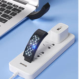 Laptop, smartwatch, and smartphone on a power strip with multiple outlets on a blue background